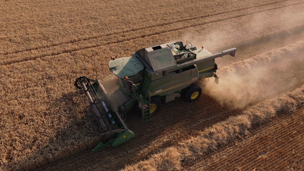 Combine harvester working in a wheat field, capturing harvest in Saigneville, France.